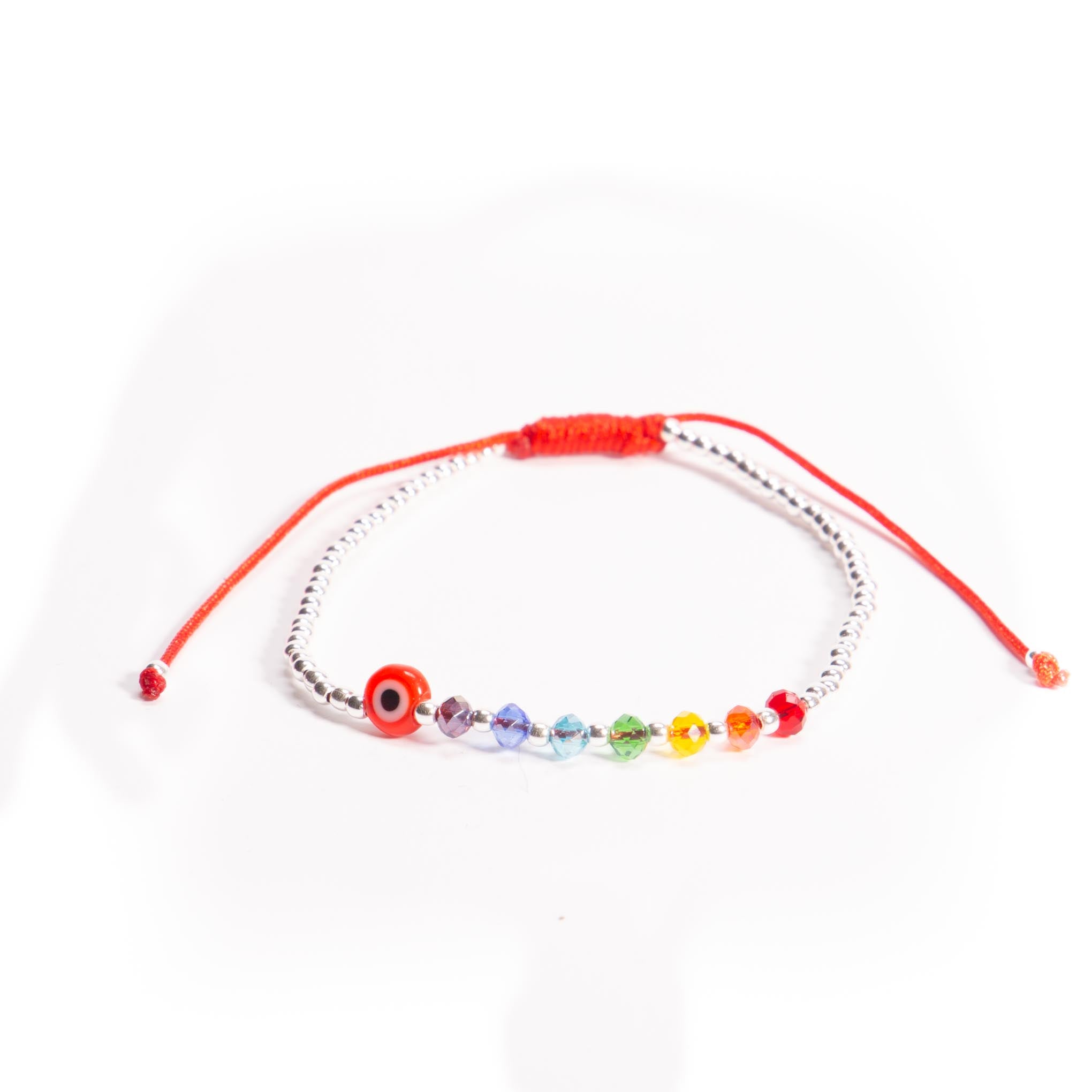 Pulsera de hilo con ojo turco, cristalitos y bolitas de plata